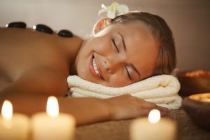 Portrait of young female enjoying spa procedure in beauty salon